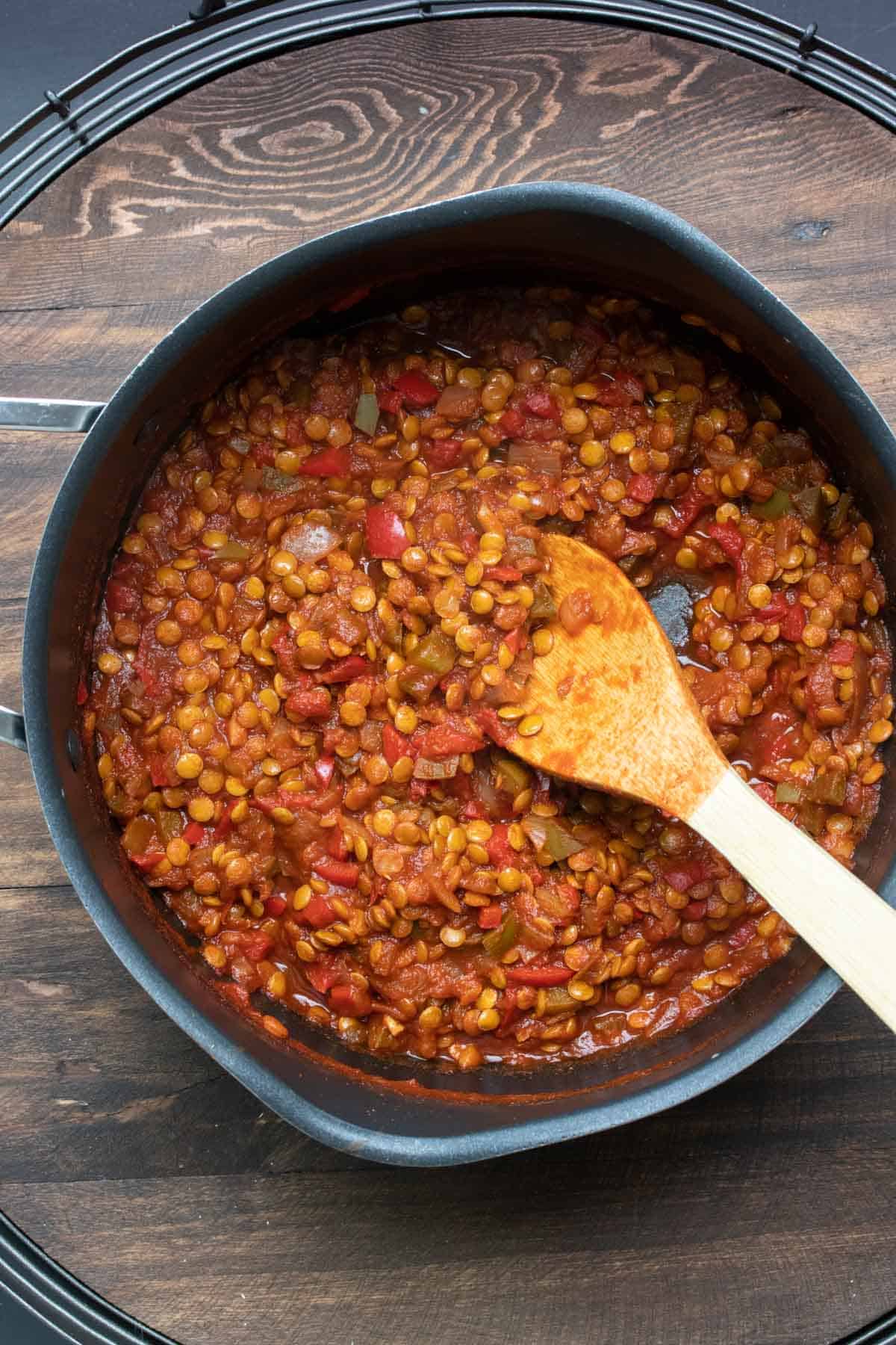 Thickened lentil sloppy joe mixture cooking in a pan.