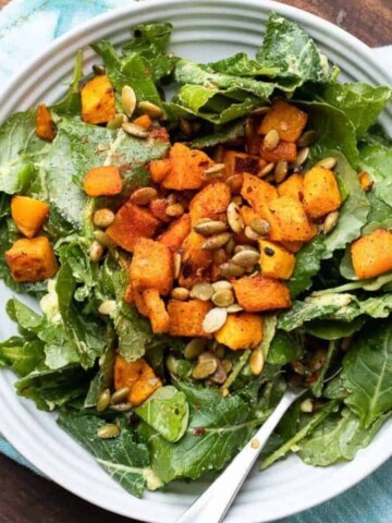 Photo of a salad with butternut squash and pumpkin seeds