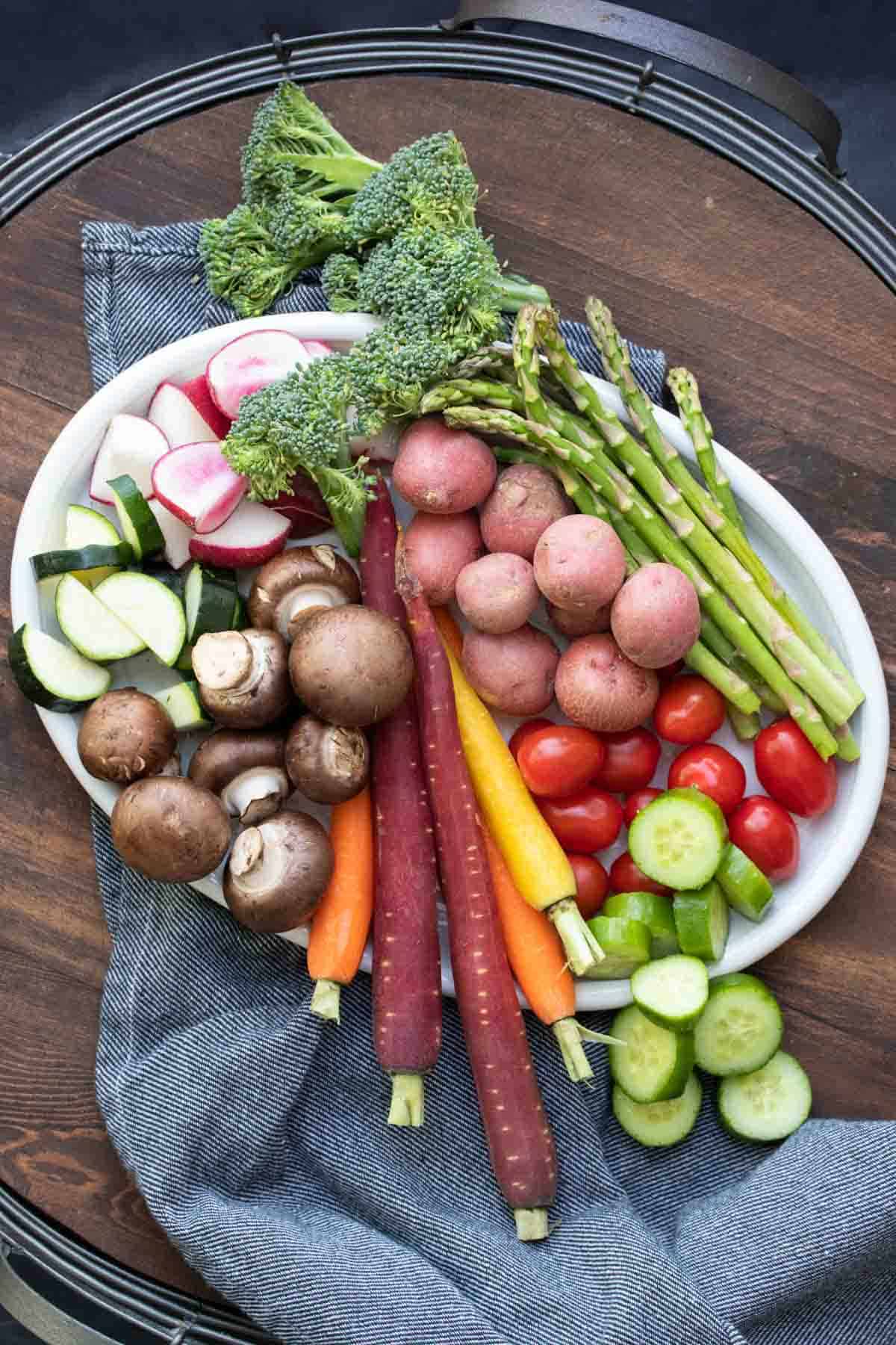 Top view of a white platter filled with different colorful vegetables