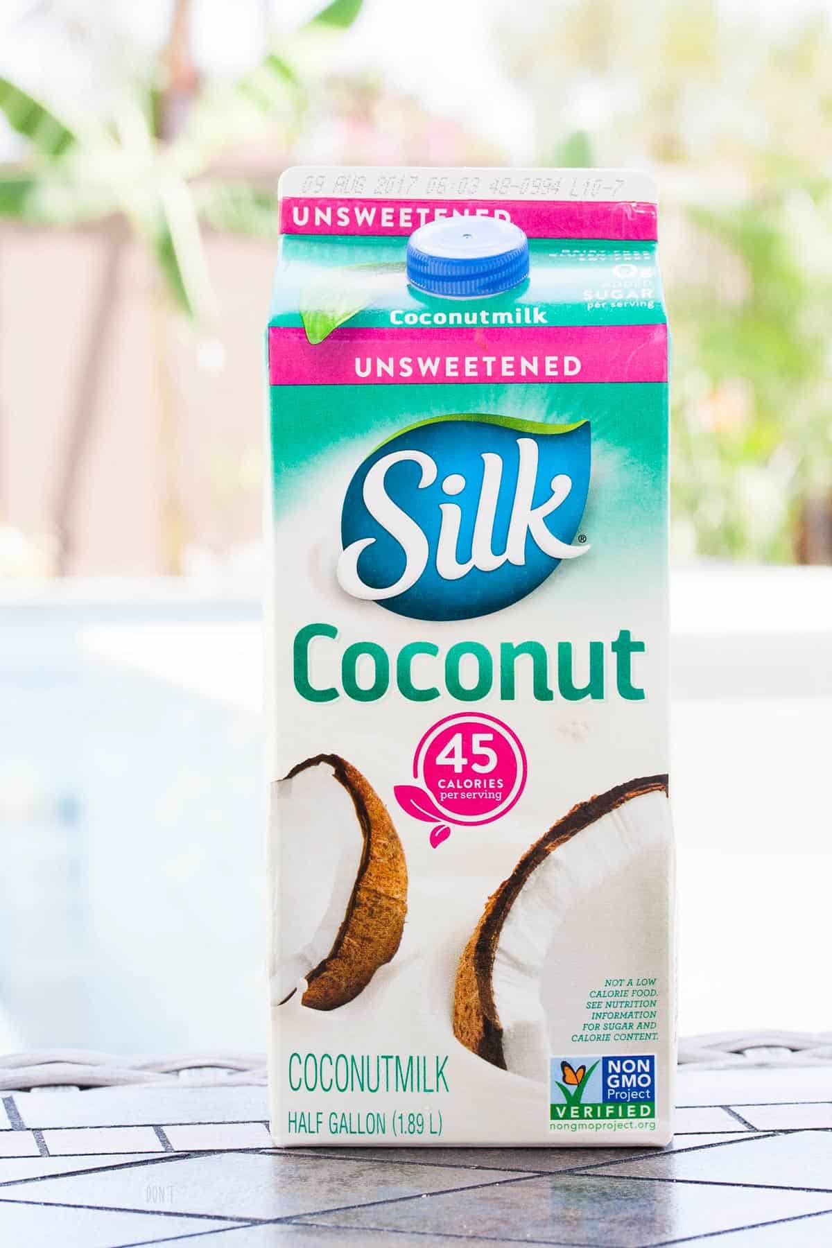 Pink, green and white carton of Silk brand coconut milk