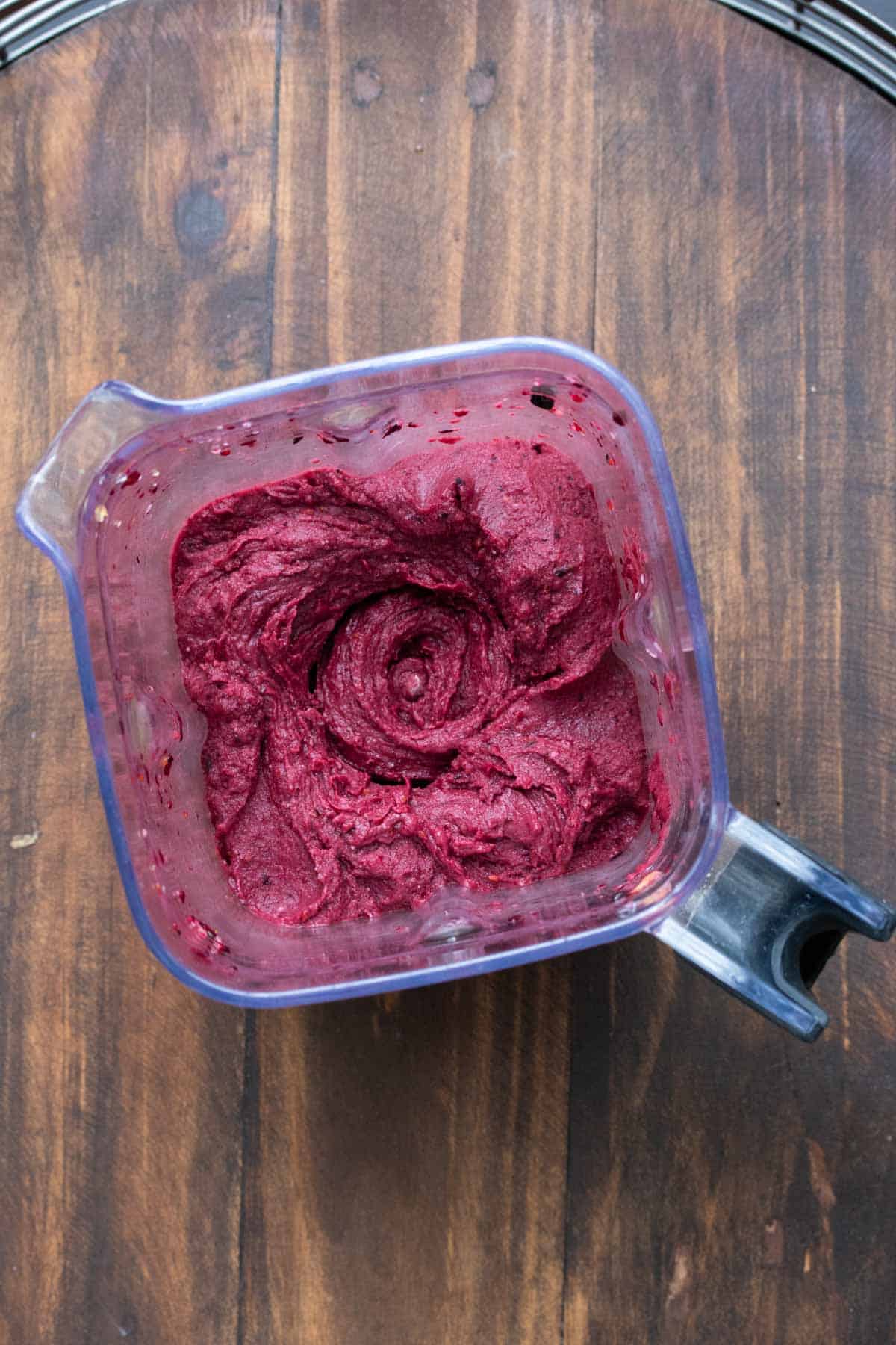 Top view of a blender with a super thick smoothie inside.