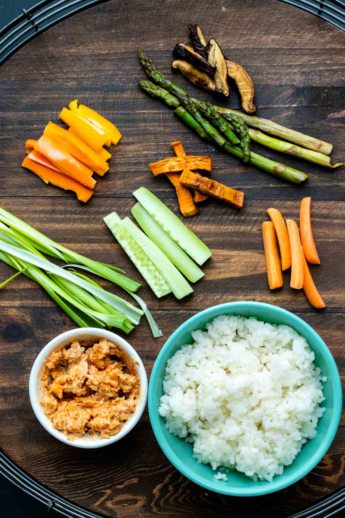 Variety of vegetable sushi ingredients on a wooden table