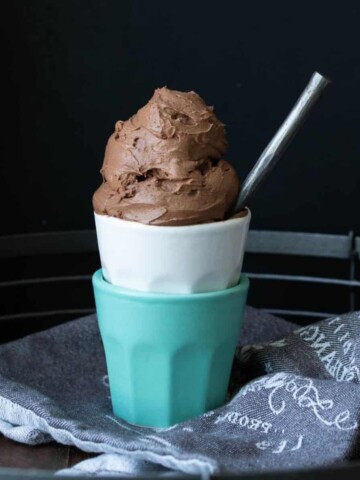 Chocolate ice cream in a turquoise cup stacked in a white cup