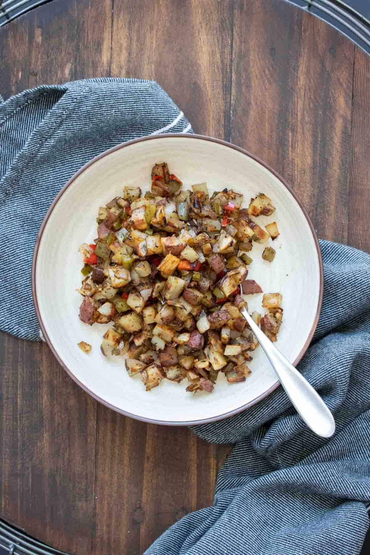 Cream bowl with cubed crispy roasted breakfast potatoes