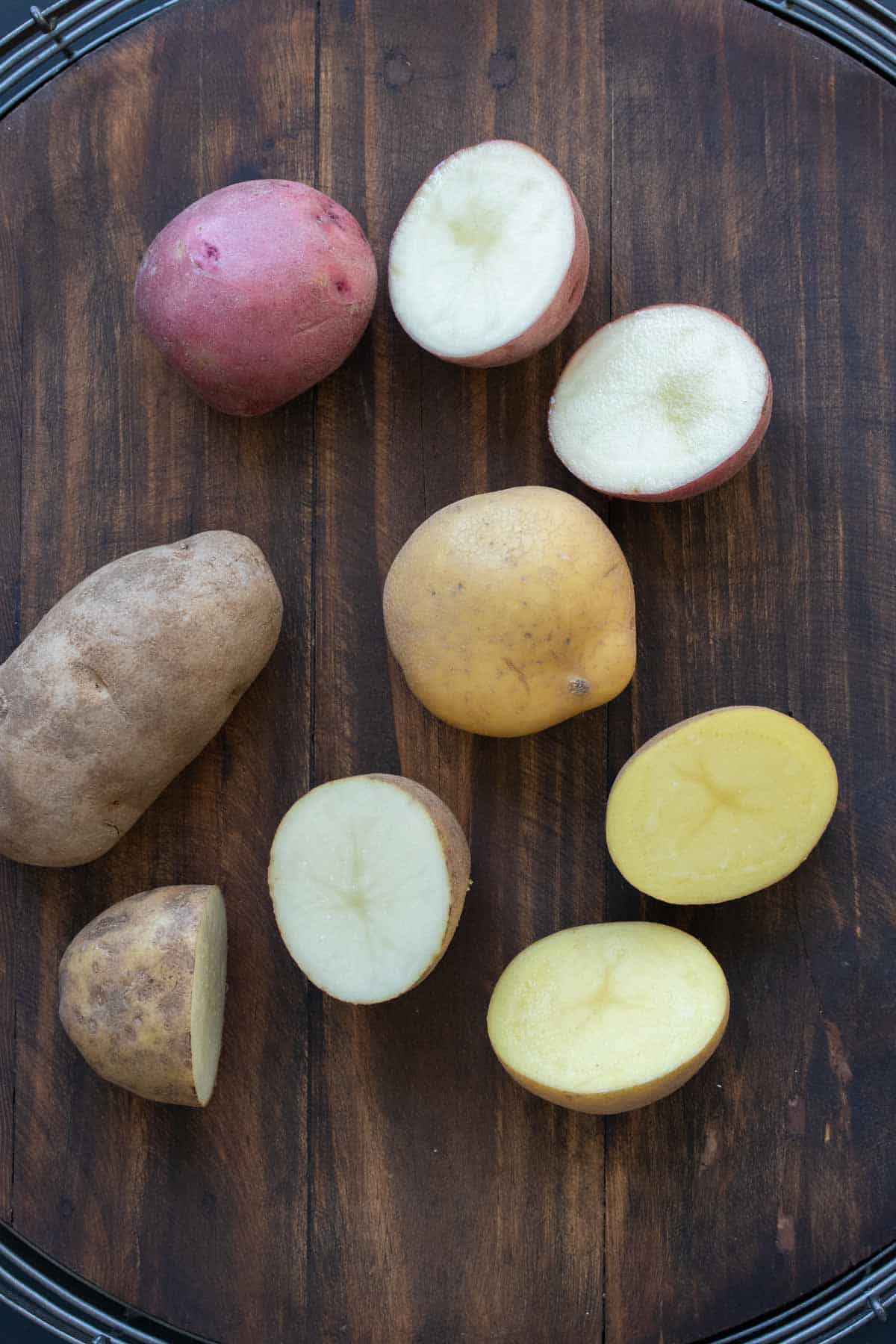 Different kinds of potatoes cut in half on a table