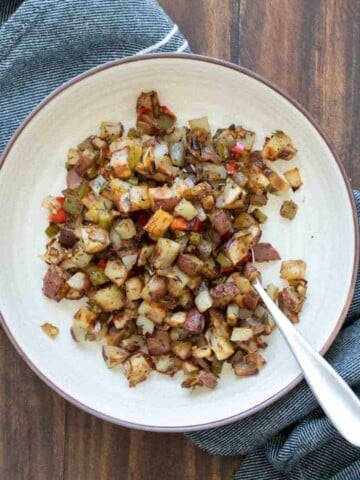 Crispy breakfast potatoes and peppers in a cream bowl