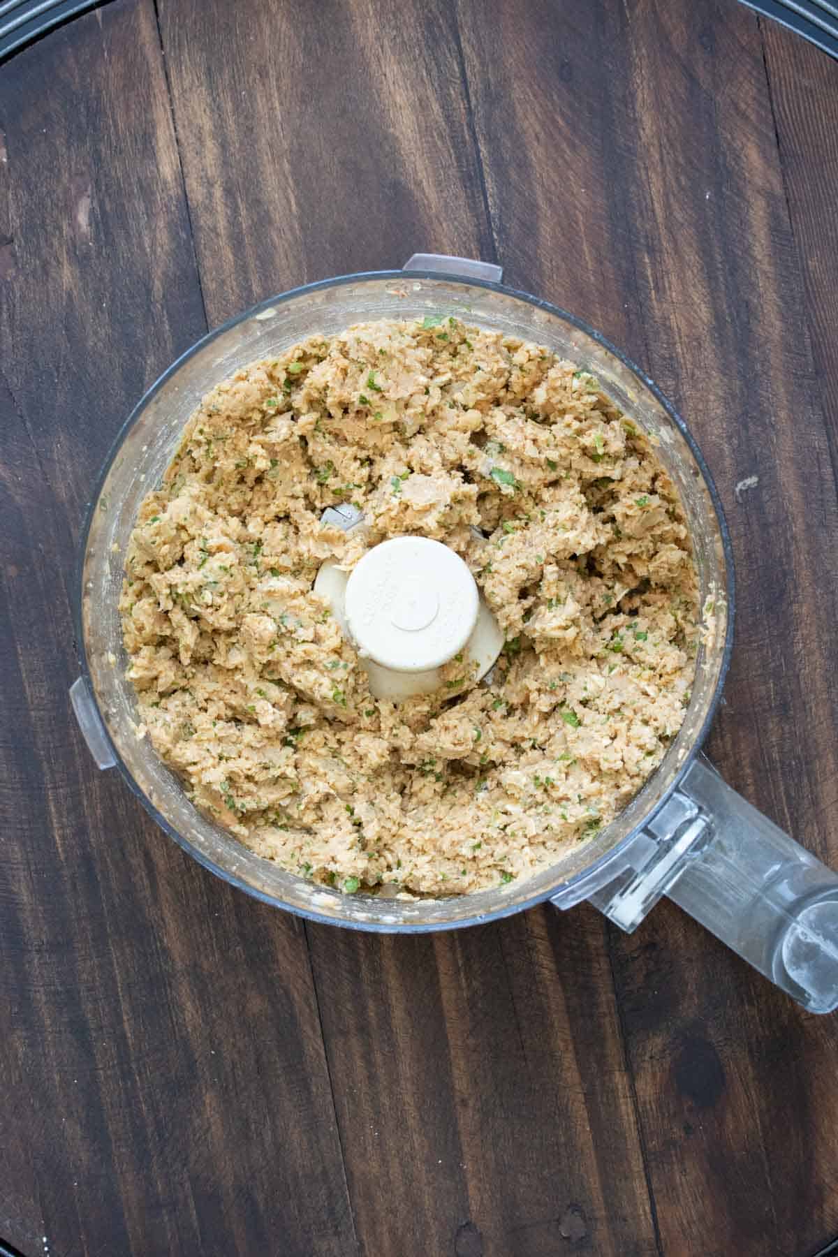 Top view of a food processor with veggie burger mixture