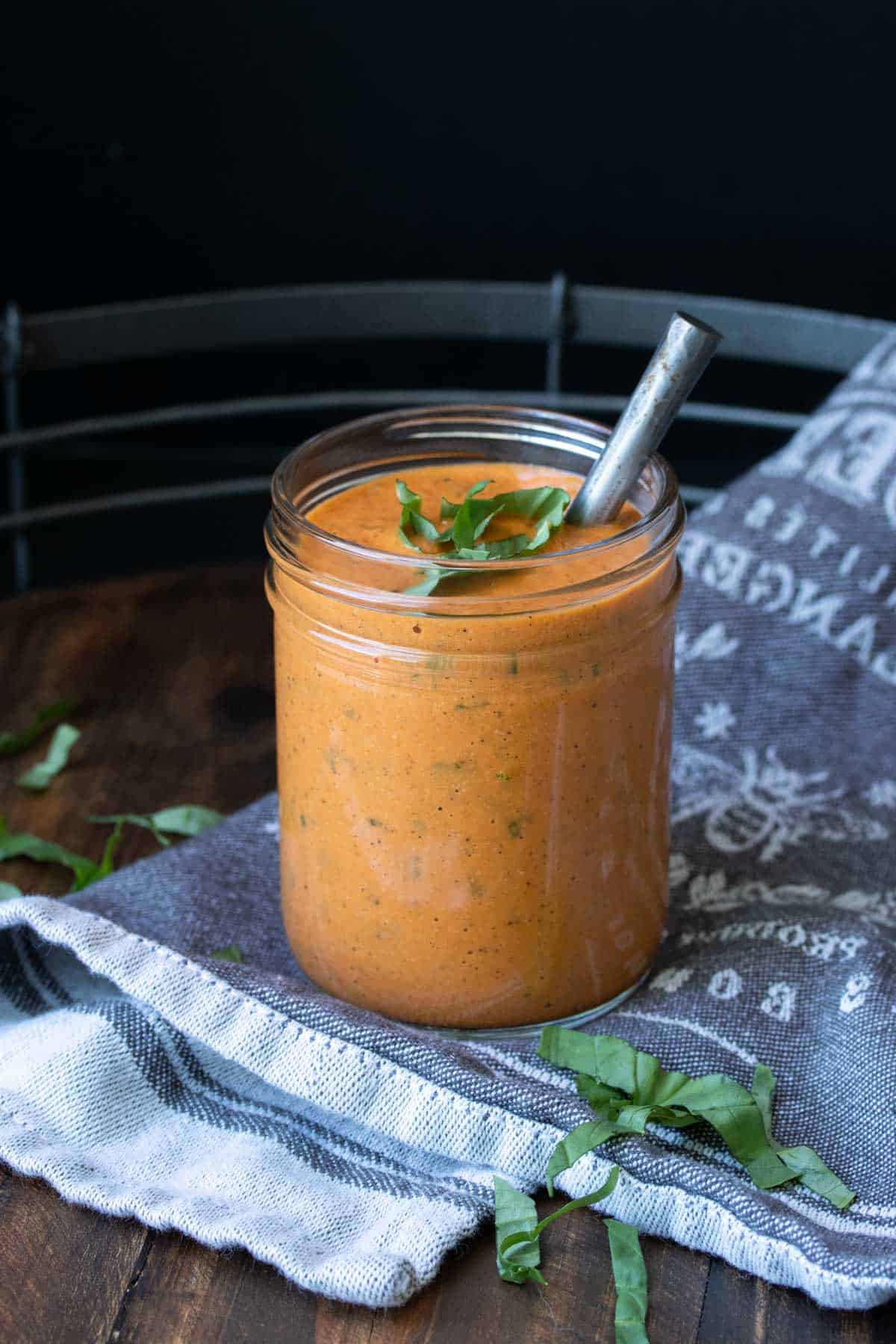 Glass jar with creamy roasted red pepper sauce in it