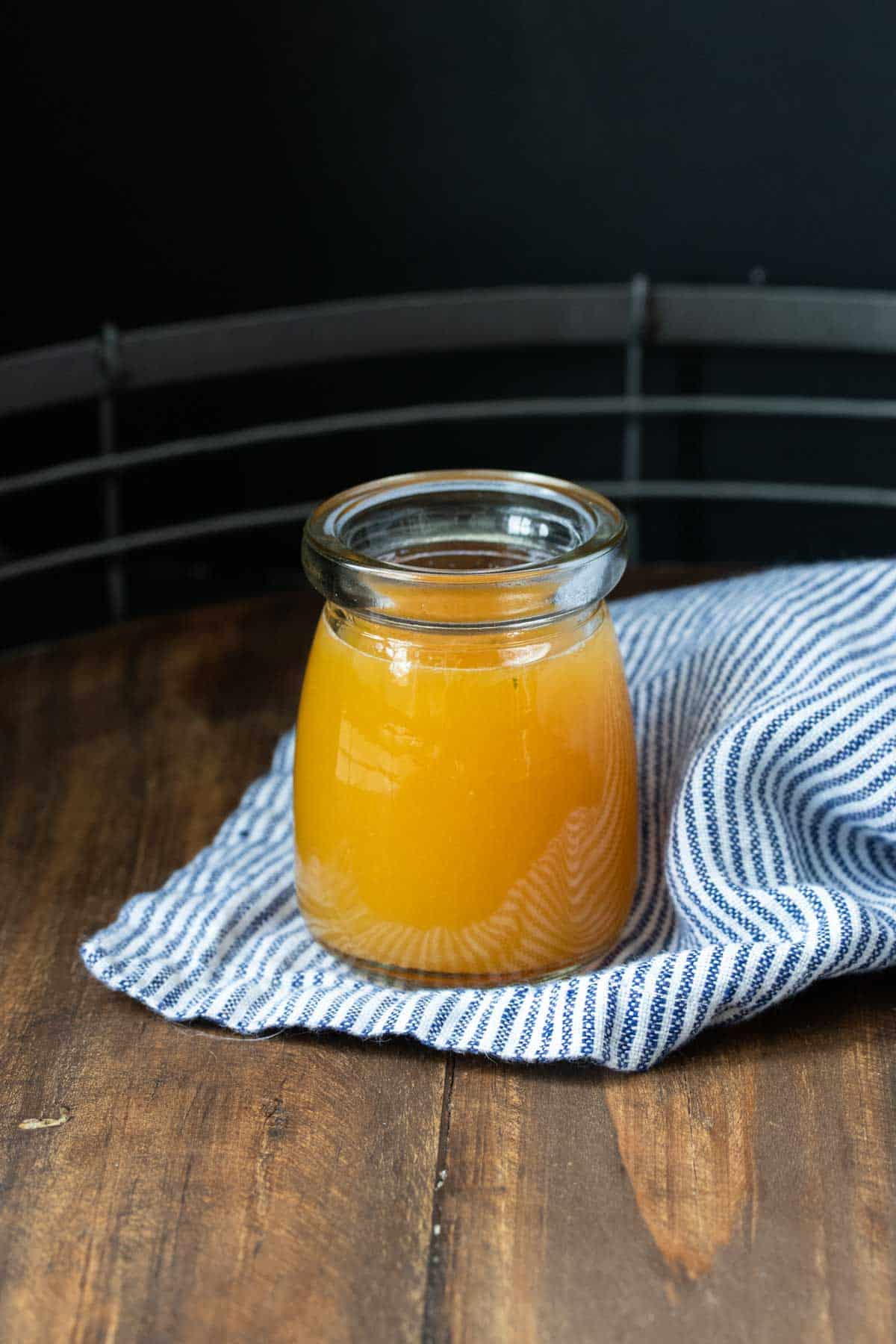 Glass jar with an orange liquid in it