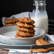 Front view of a stack of chocolate chip cookies on a grey plate