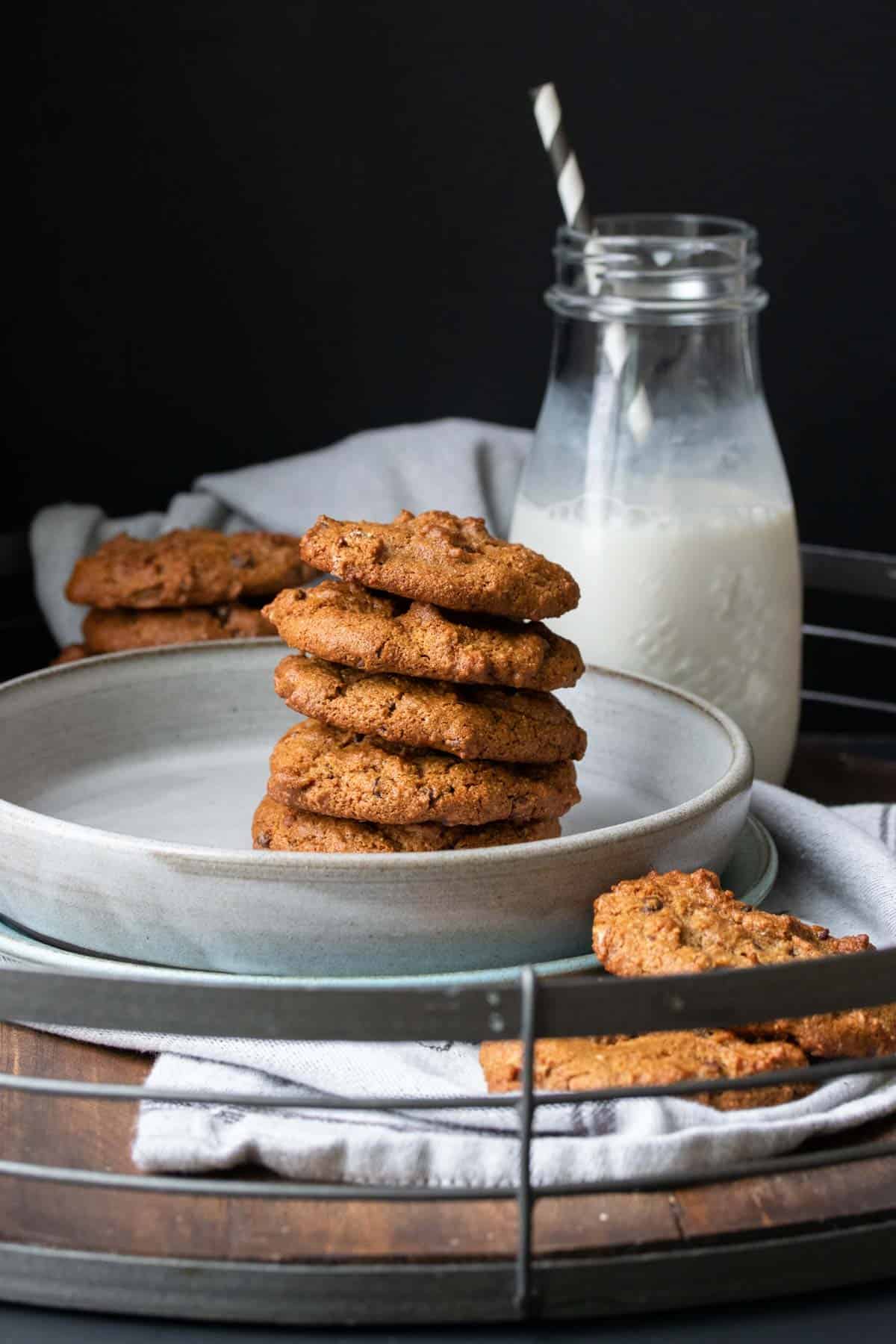 Front view of a stack of chocolate chip cookies on a grey plate