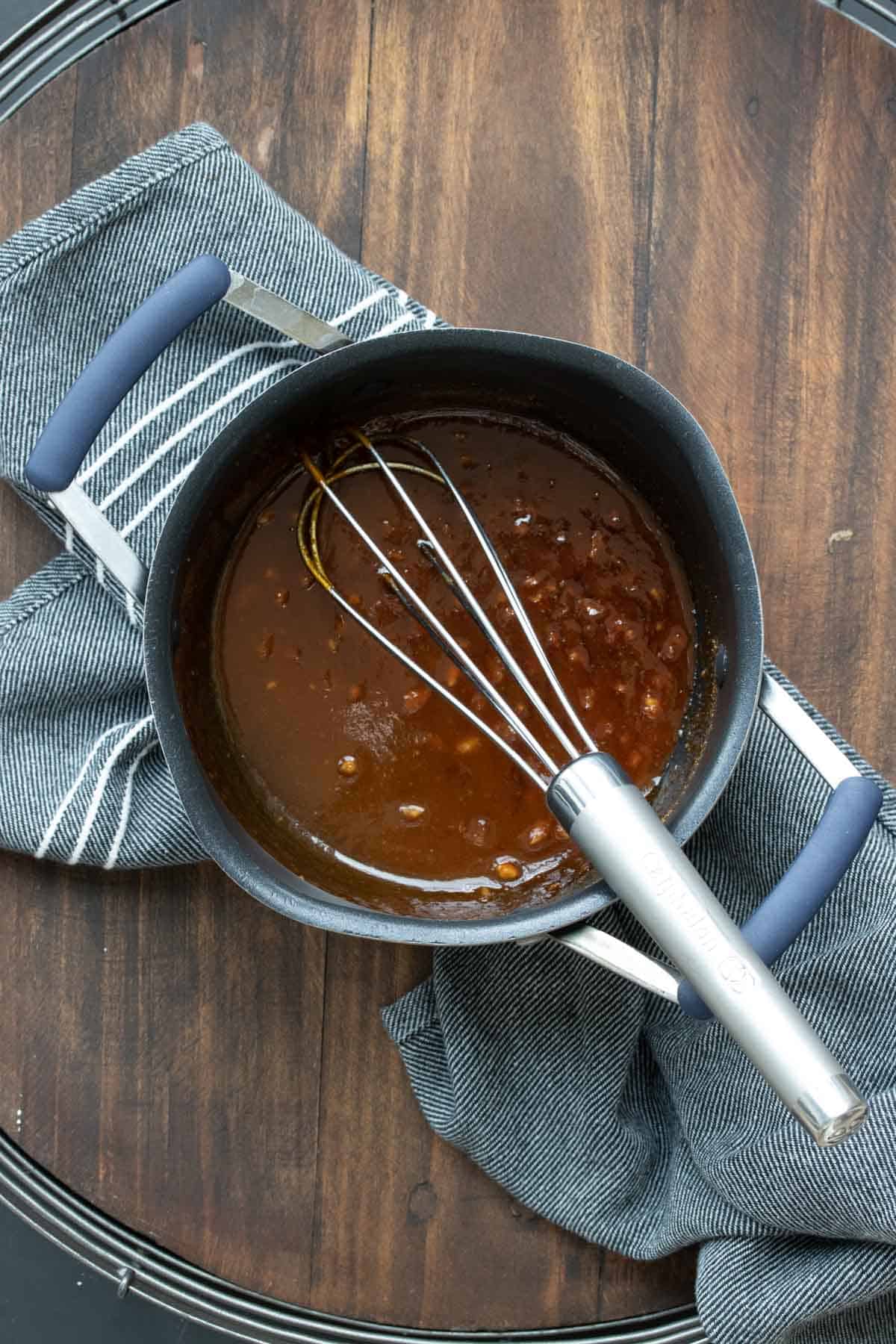 Whisk mixing brown sauce in a pot