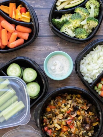 Photo of containers filled with prepped veggies on a wooden surface