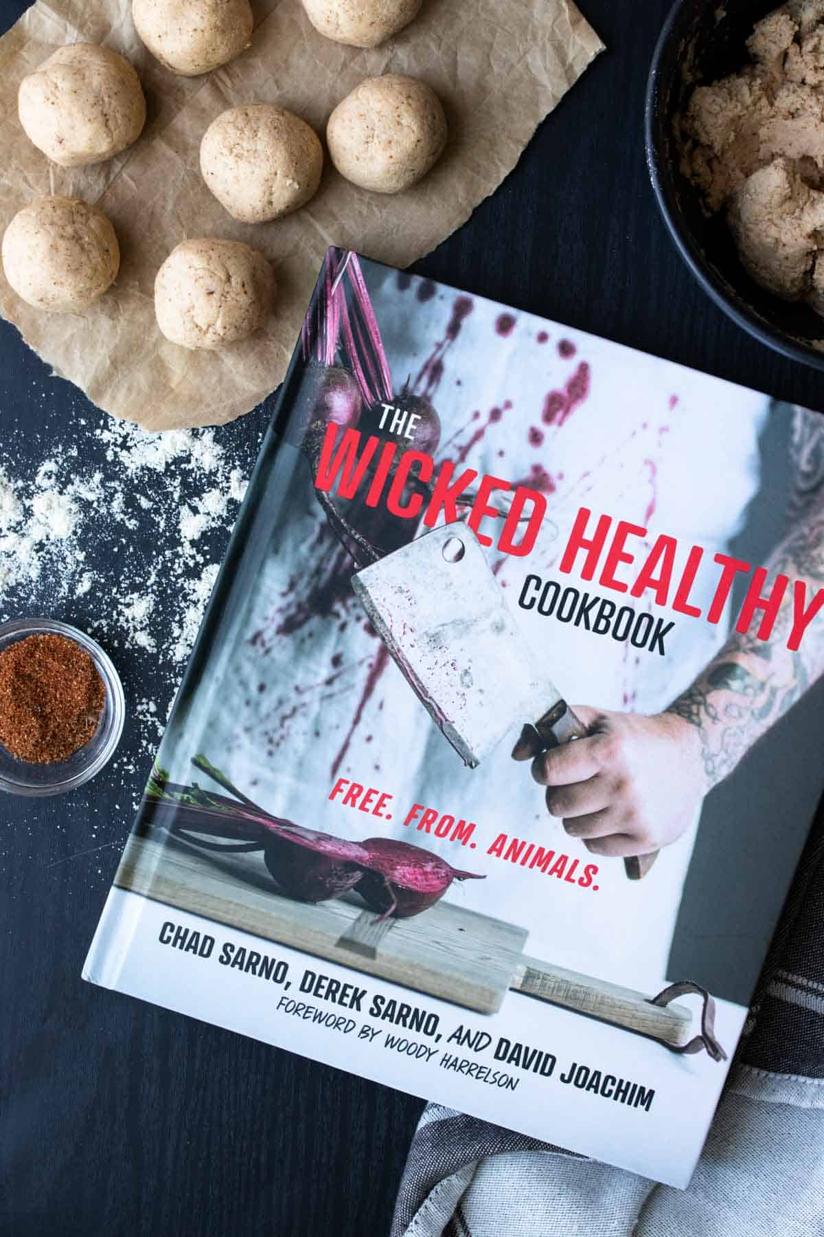 Cookbook with a butcher knife on the cover sitting on a black table