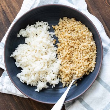 Black bowl with brown and white rice in it