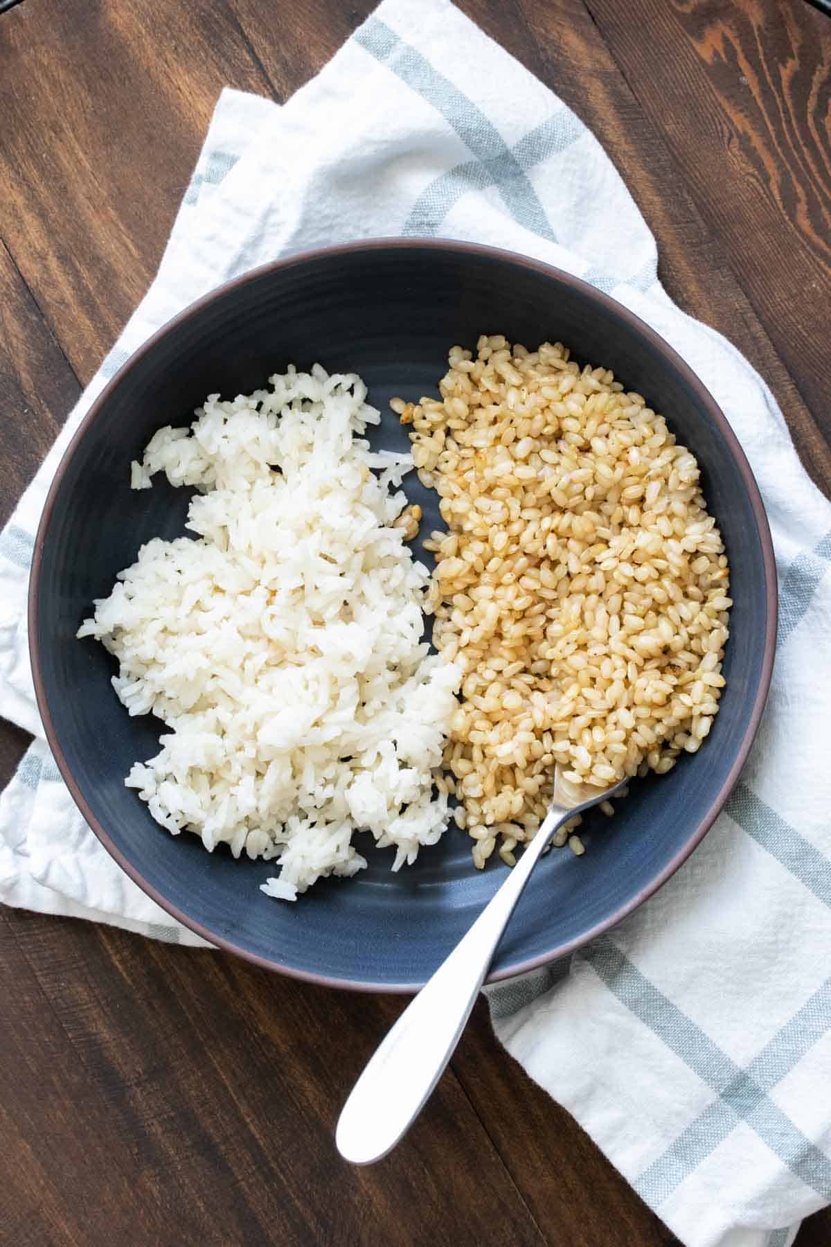 Black bowl with brown and white rice in it