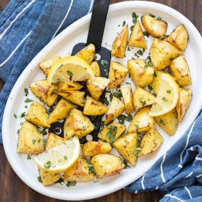 White platter with oven roasted pieces of potato topped with oregano