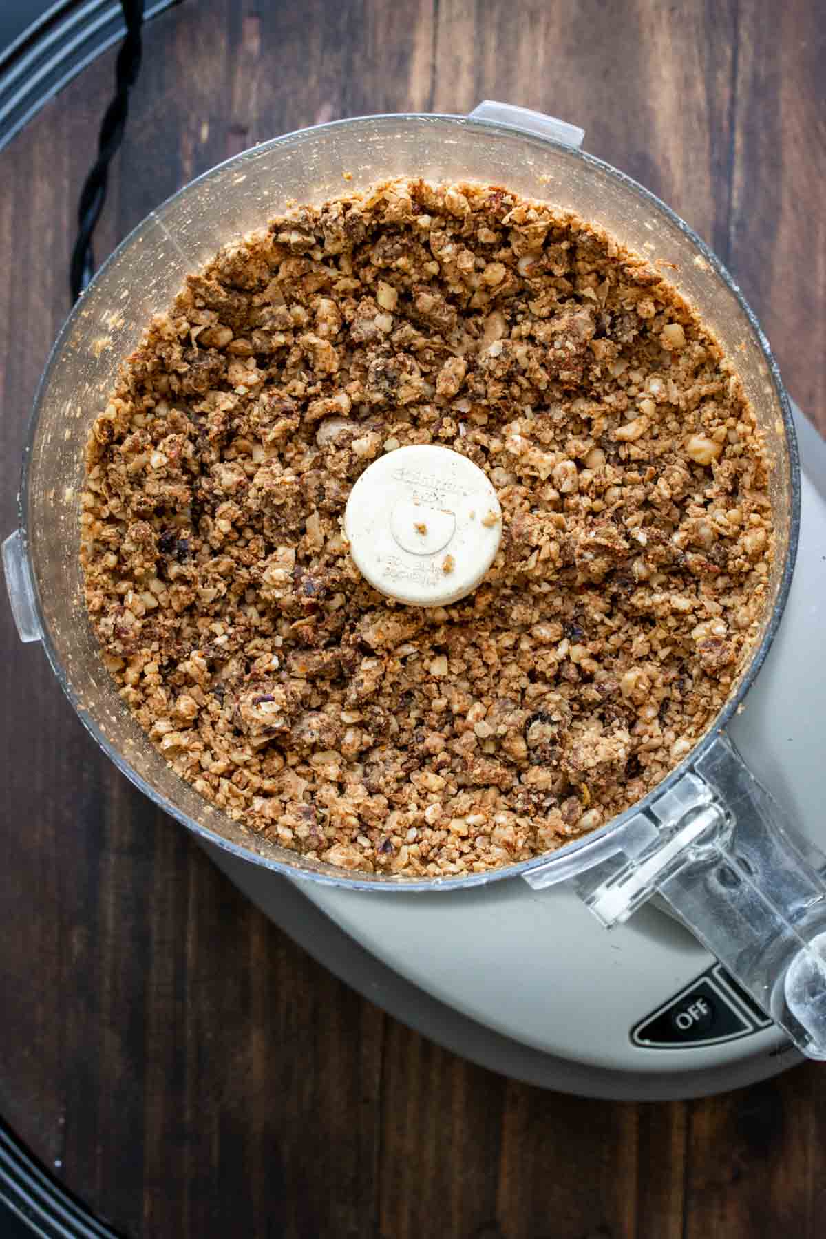 Top view of a food processor with vegan chorizo crumbles in it