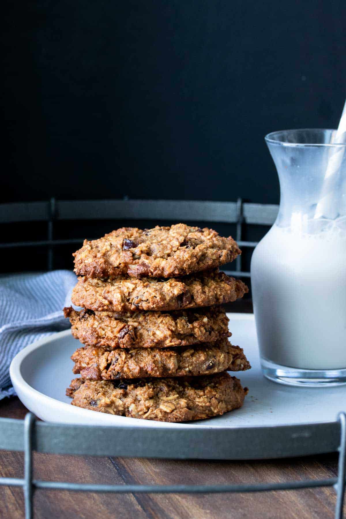 A stack of oatmeal raisin cookies on a grey plate