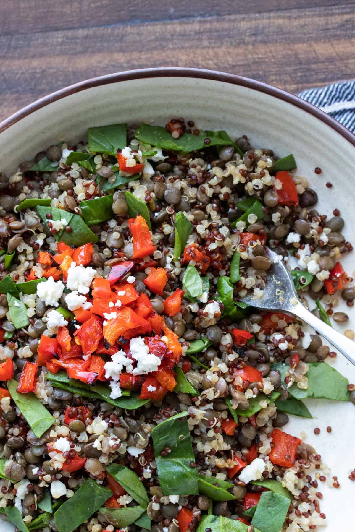 For getting a bite of lentil quinoa salad from a white bowl