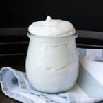 Close up of a jar filled with coconut whipped cream.