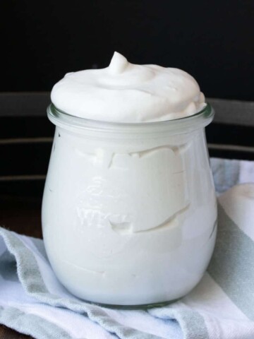 Close up of a jar filled with coconut whipped cream.