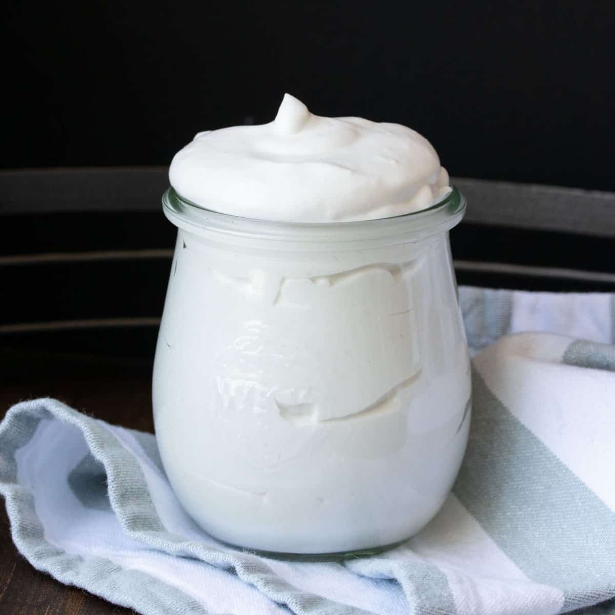 Close up of a jar filled with coconut whipped cream