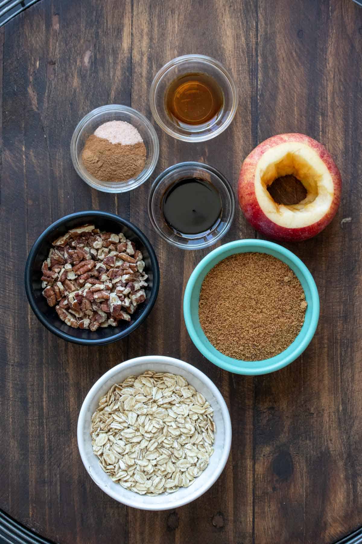 Different colored bowls filled with ingredients for baked apples.