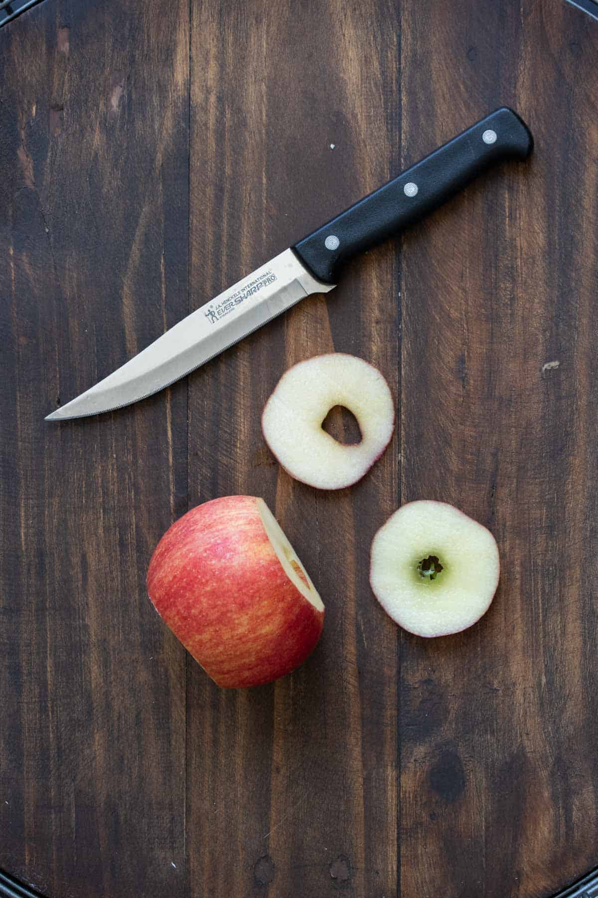 Red apple on its side with the top and bottom sliced off