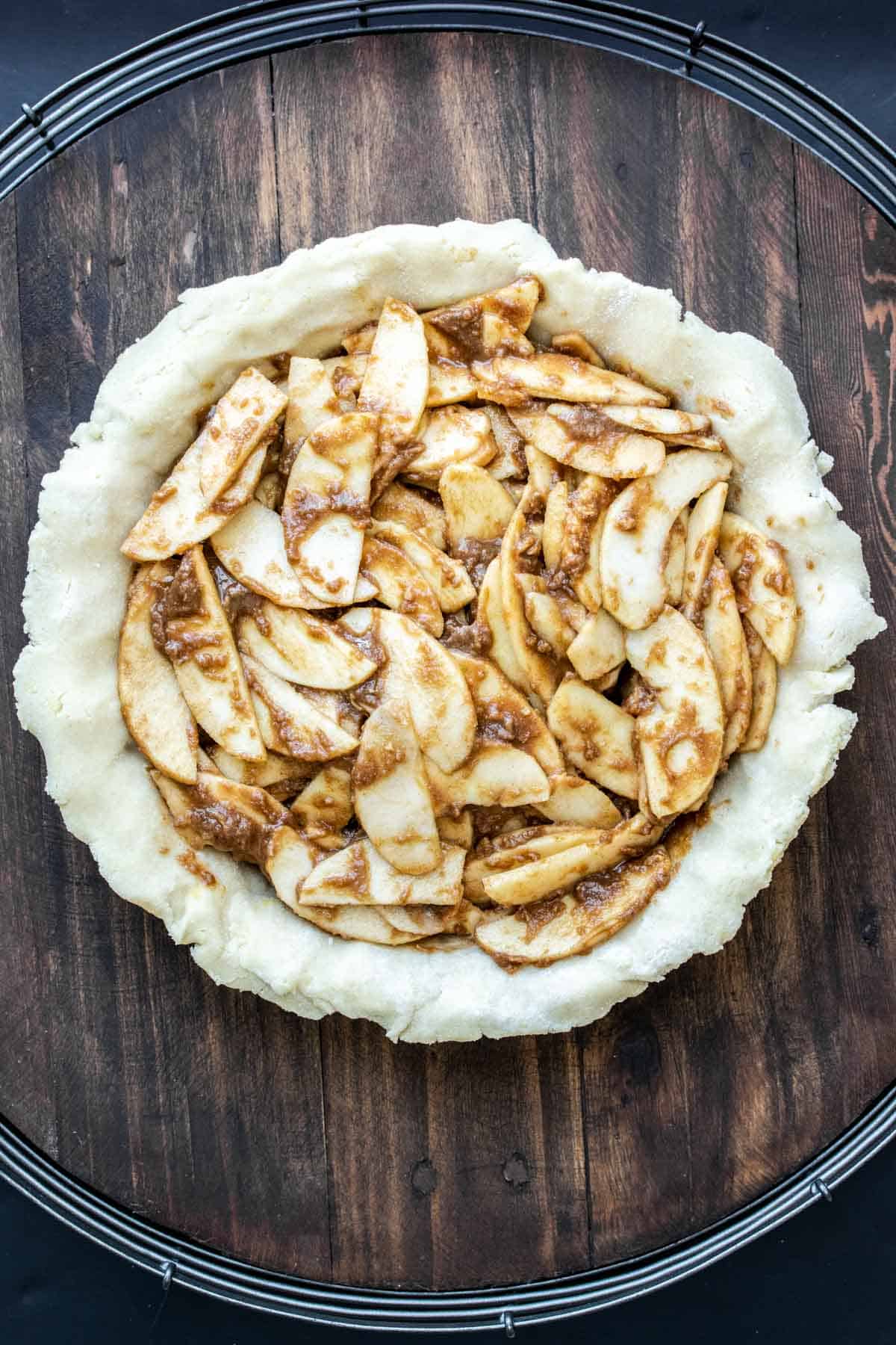 Raw pie crust filled with apple pie filling