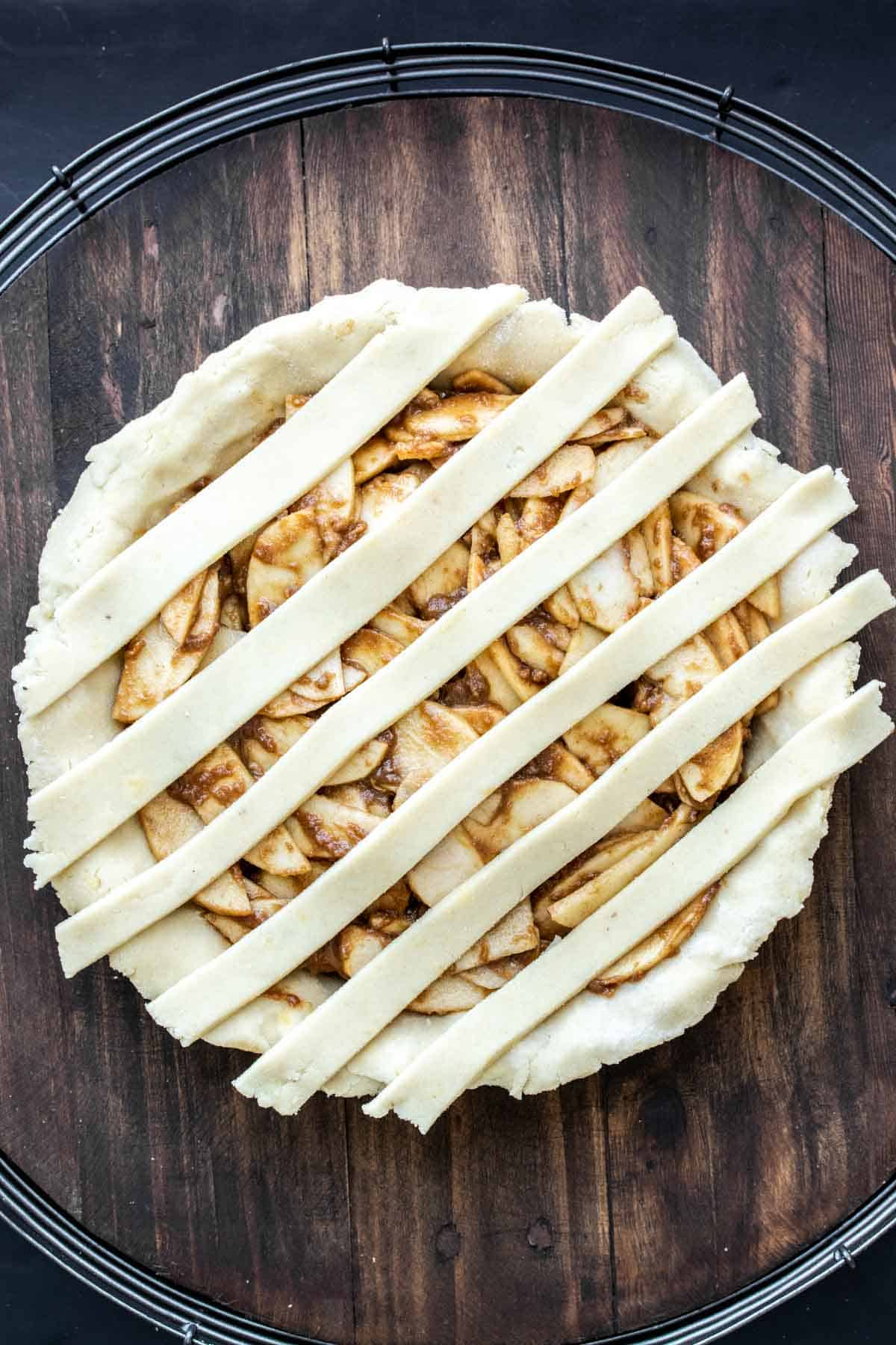 Raw apple pie with strips of pie dough on top