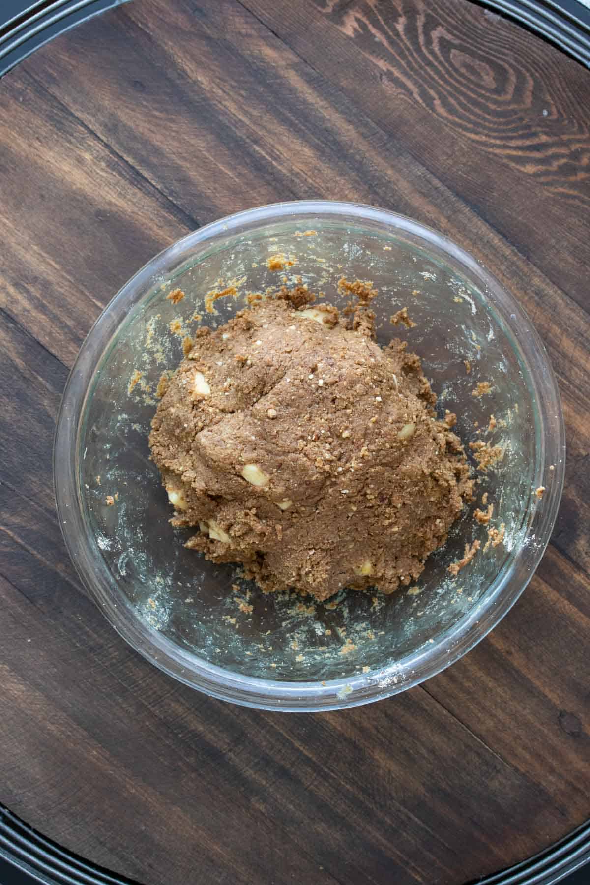 Glass bowl with a ball of brown dough