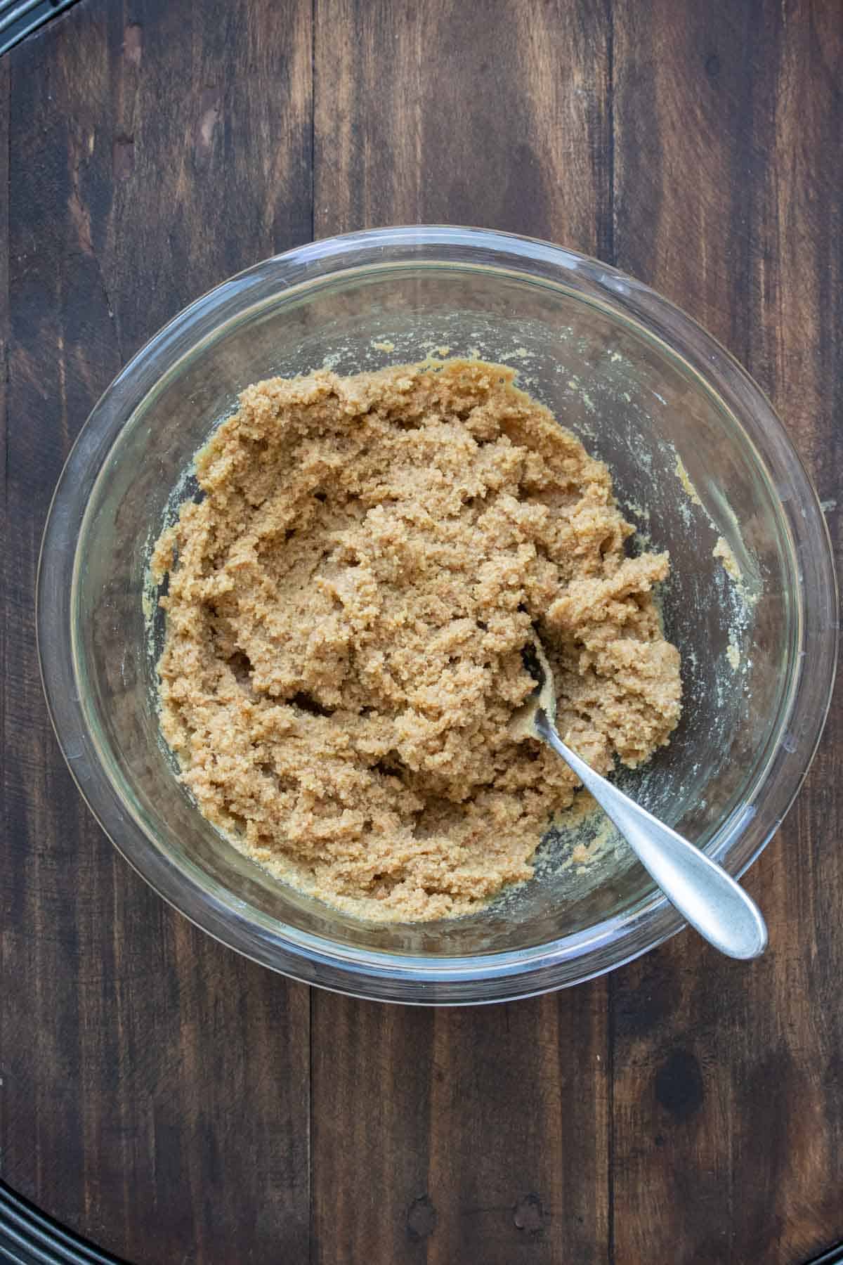 Glass bowl with cookie dough being mixed