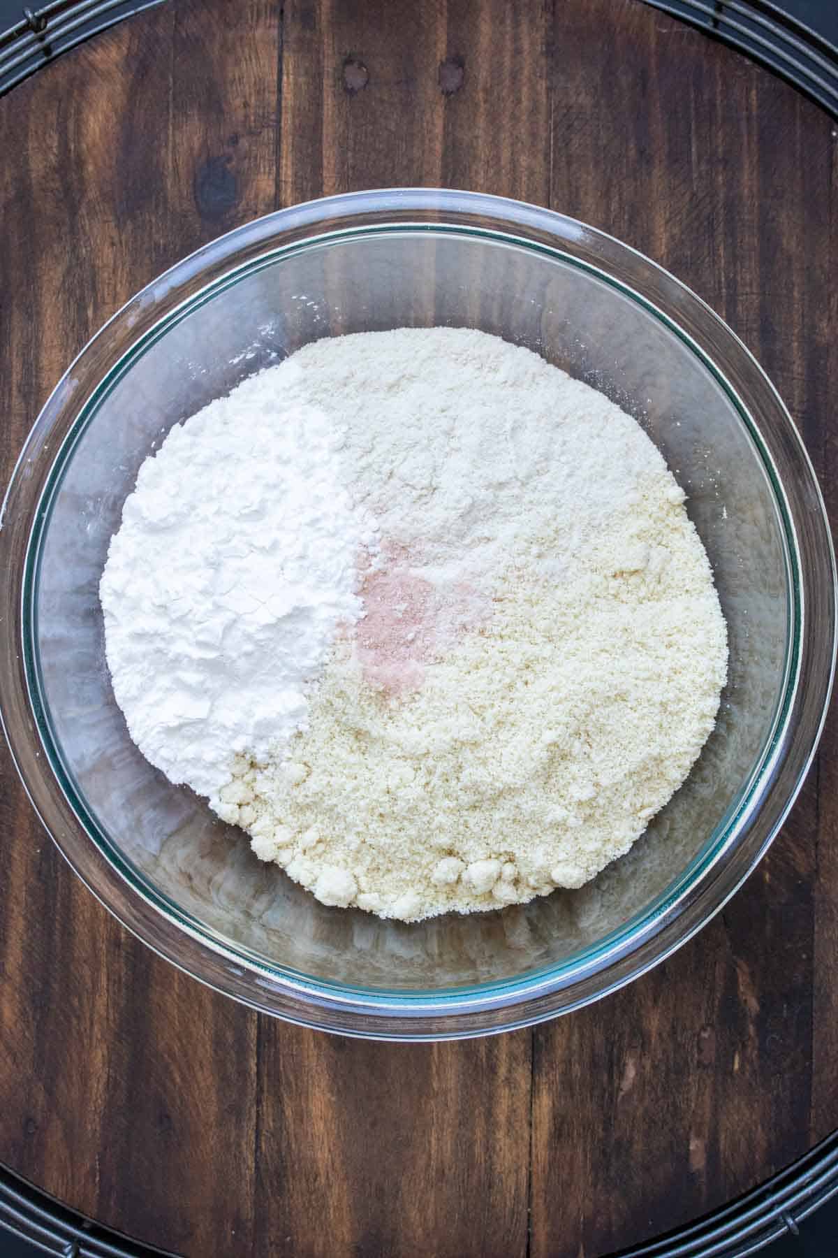 Glass bowl filled with different flours and salt