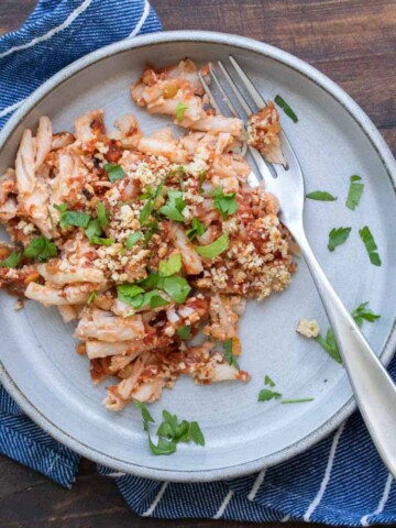 Serving of baked pasta and sauce on a grey plate