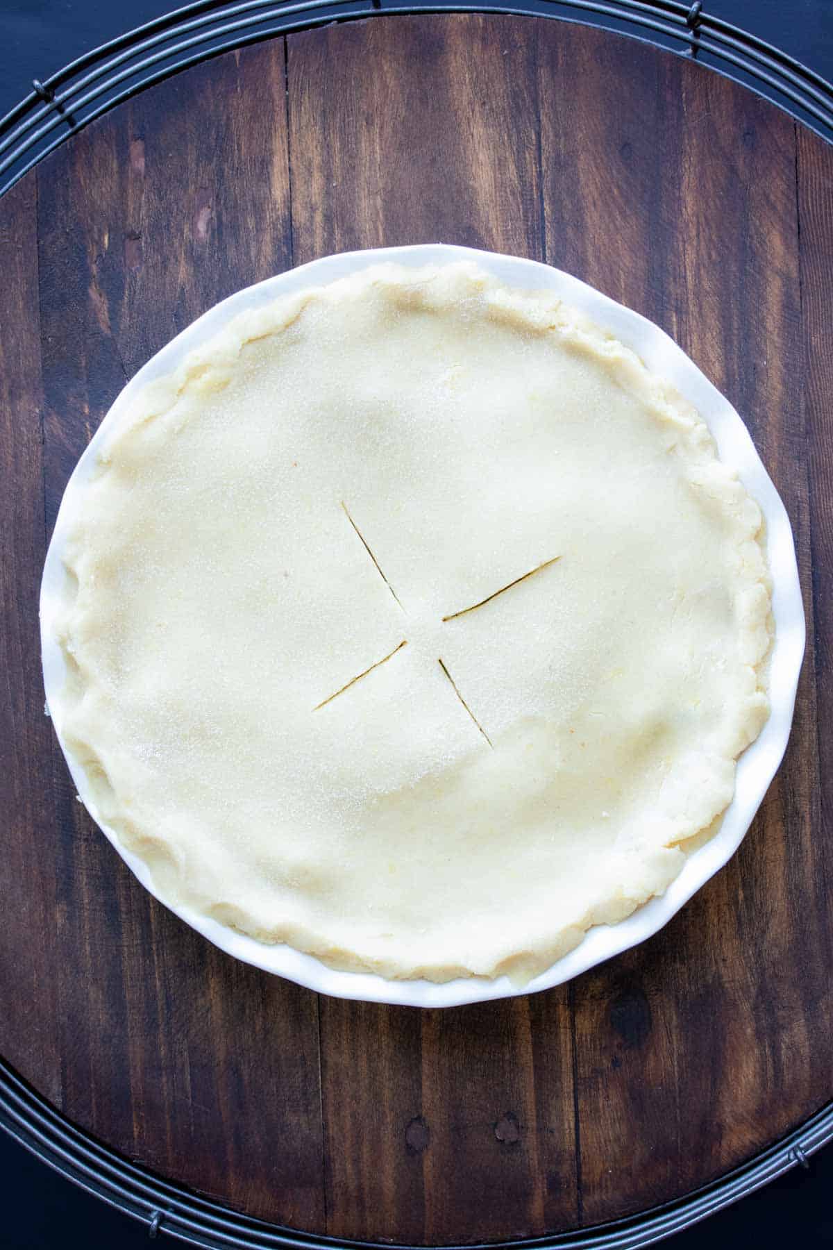 Top view of an unbaked vegetable pot pie in a pie dish.