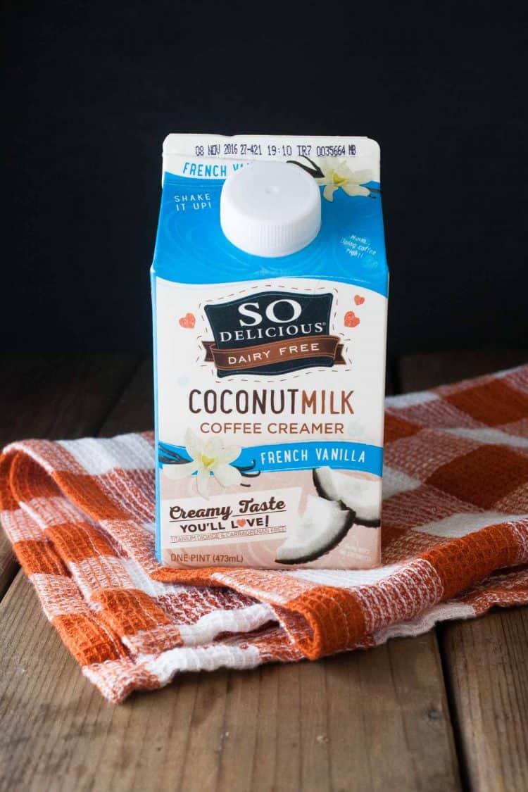 Blue and white carton of coconut coffee creamer on an orange checked towel