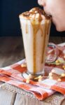 Boy taking a sip of a pumpkin spice latte with caramel drizzle