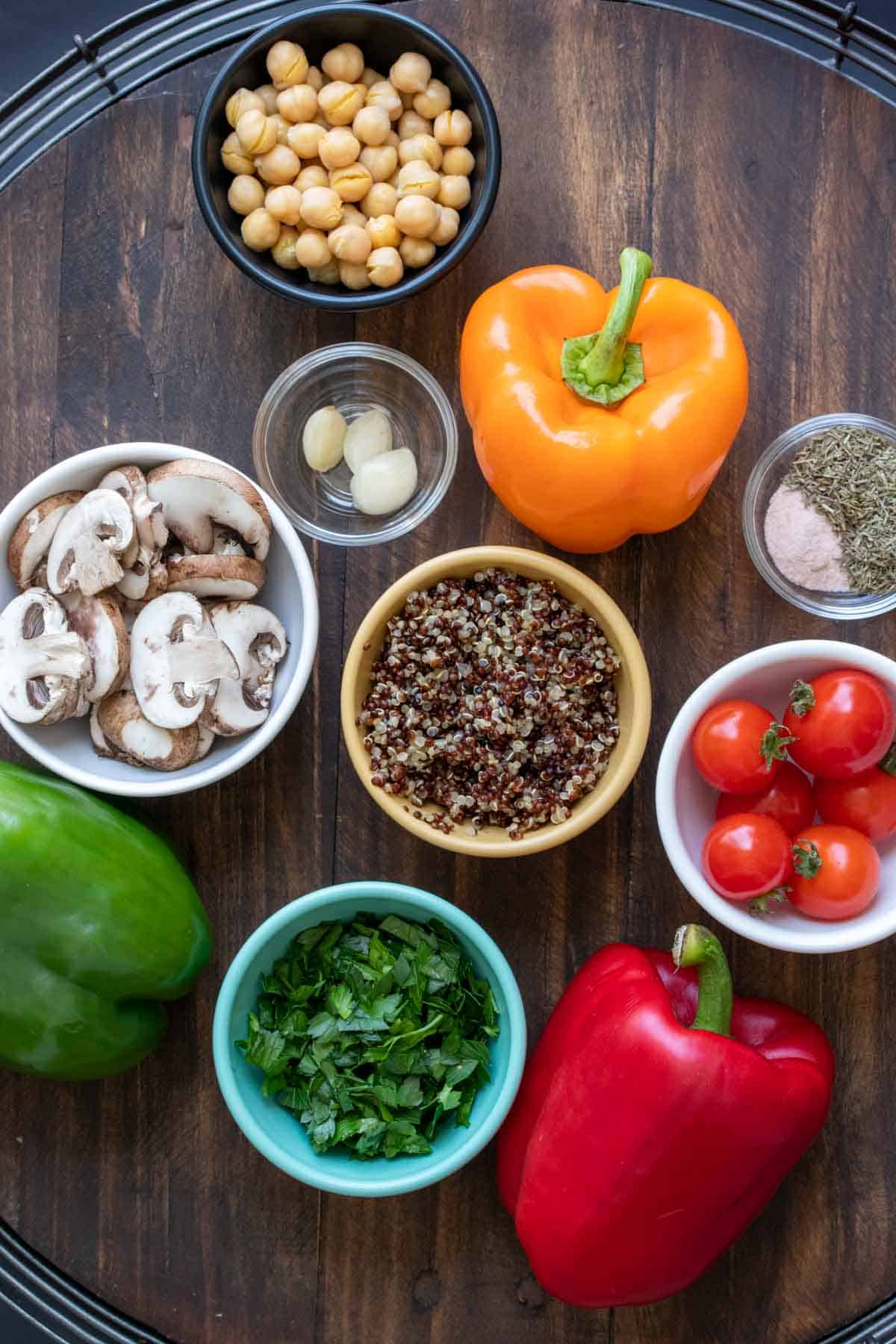 Ingredients used for stuffed peppers in bowls and on the wooden table