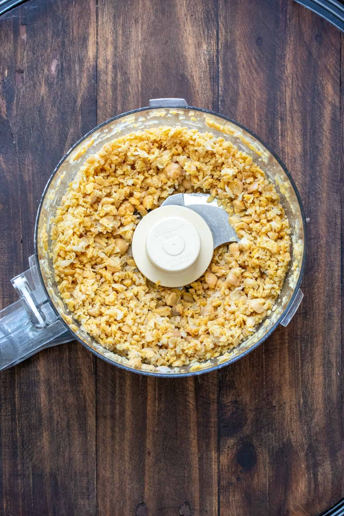 Top view of food processor with chopped chickpeas