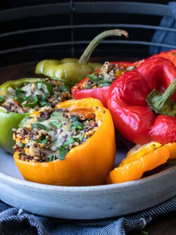 Grey plate with different colored stuffed peppers on it