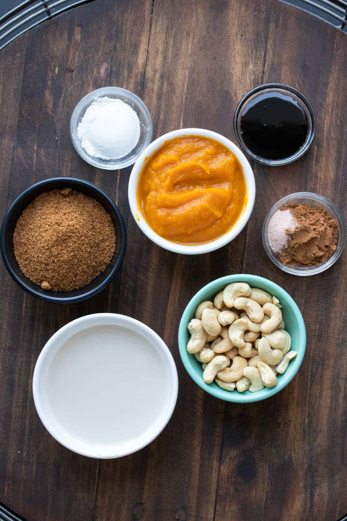 Ingredients for pumpkin pie filling in different colored bowls