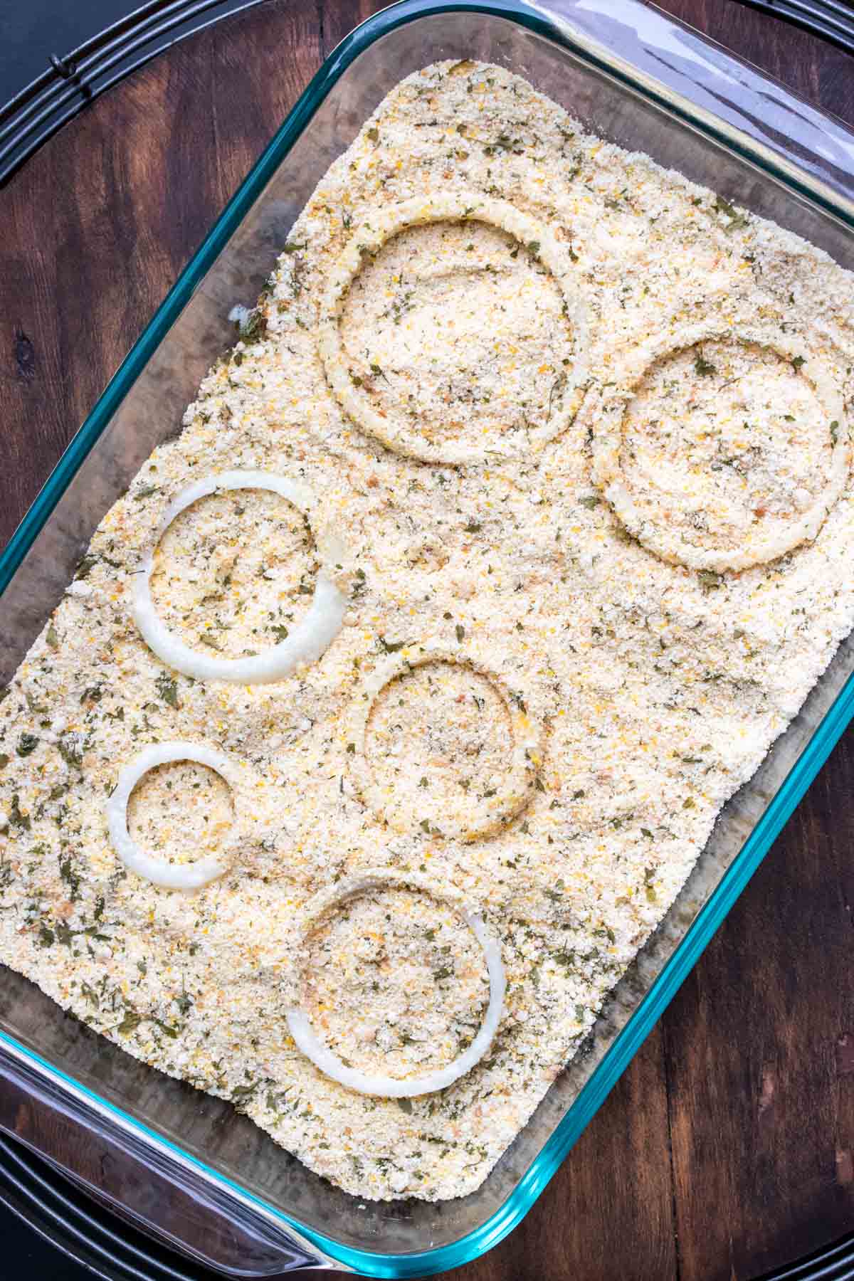 White onion slices in a pan of crispy coating