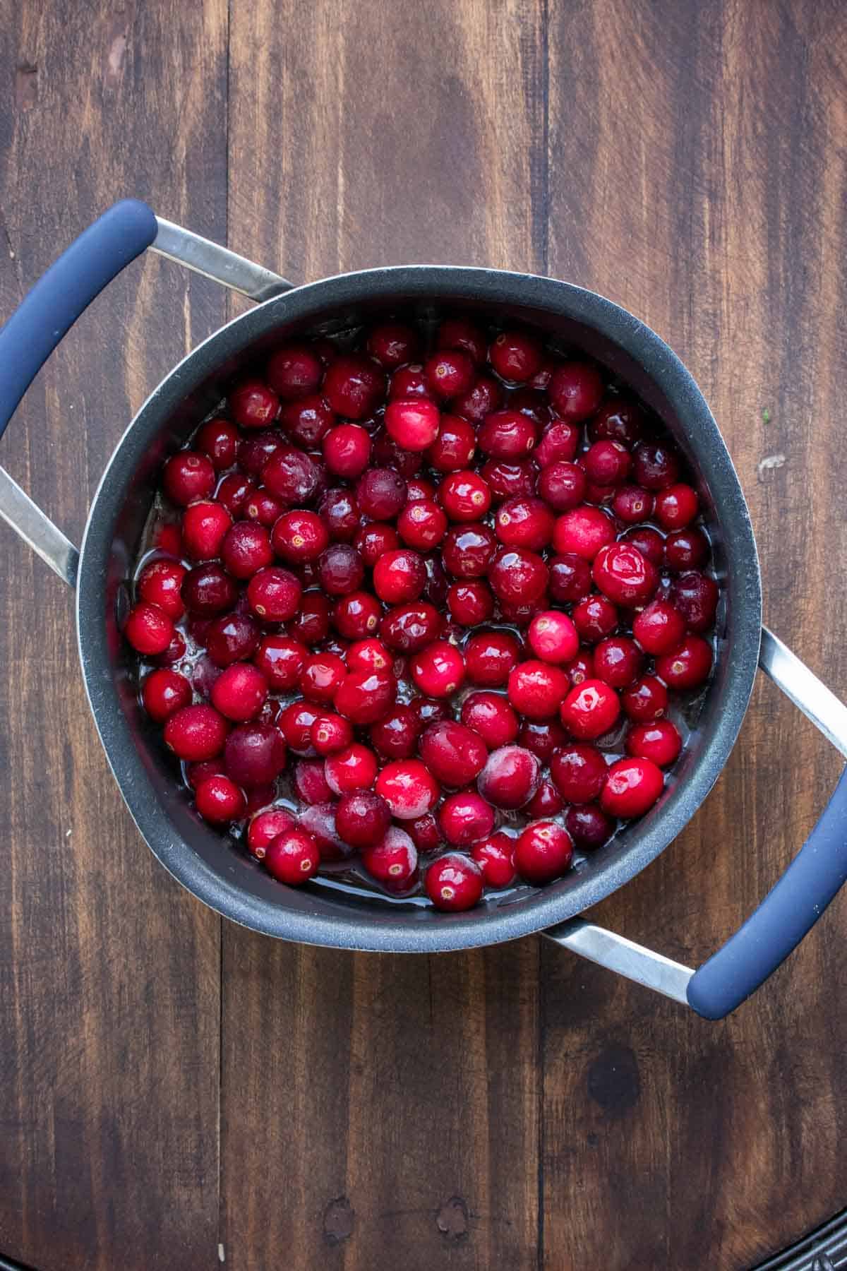 Cranberries in a pot simmering to become sauce