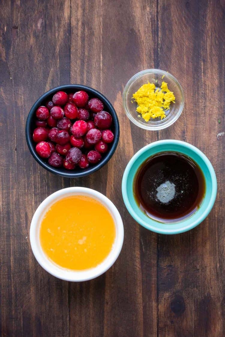 Bowls with ingredients for cranberry sauce made with orange juice