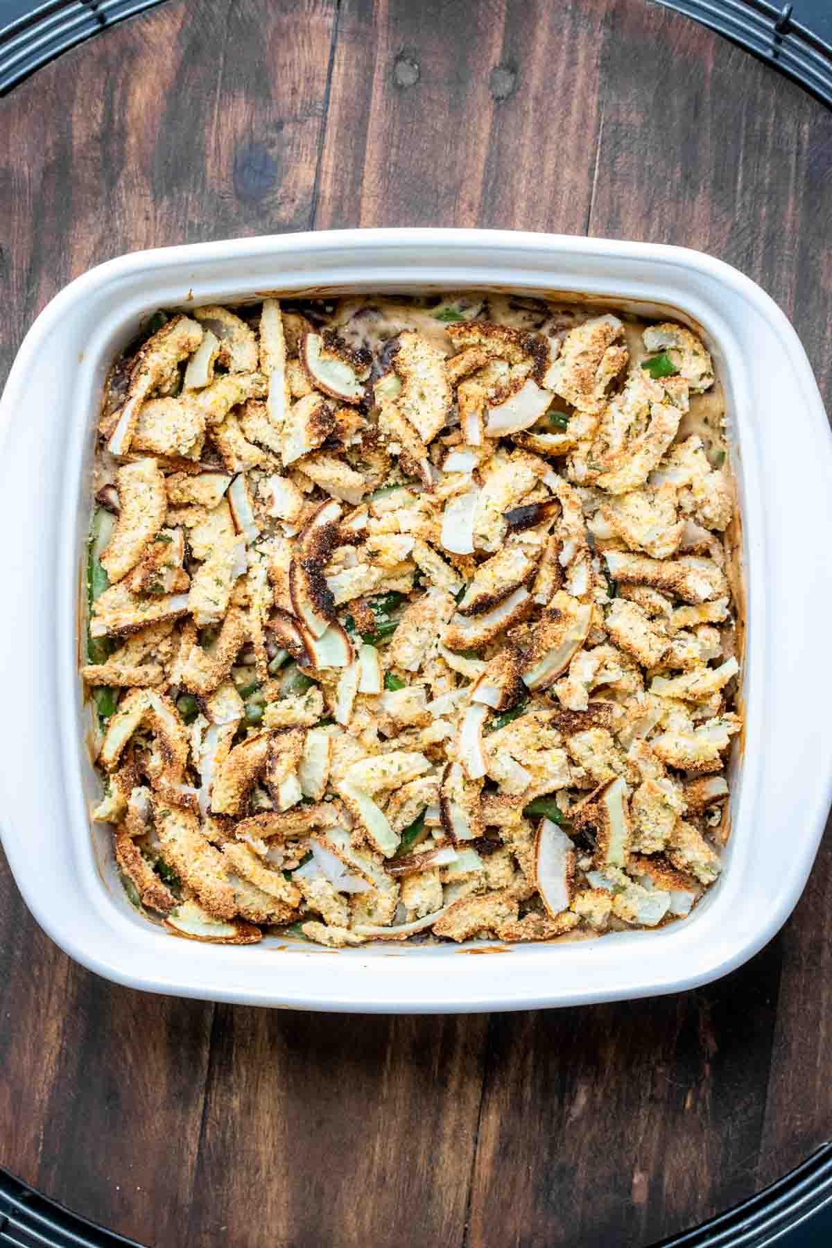 White baking dish with green bean casserole covered with crispy onions