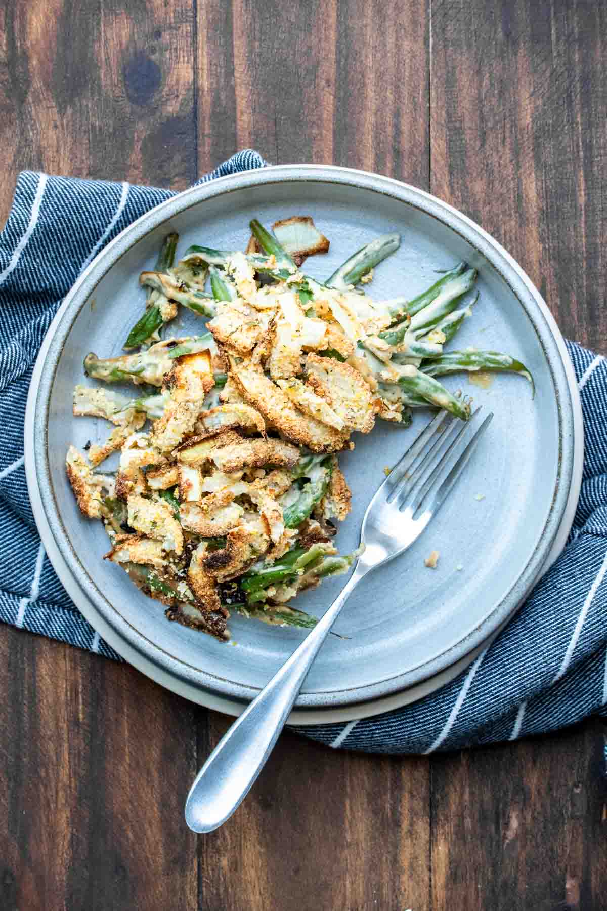 Grey plate with a serving of green bean casserole on it