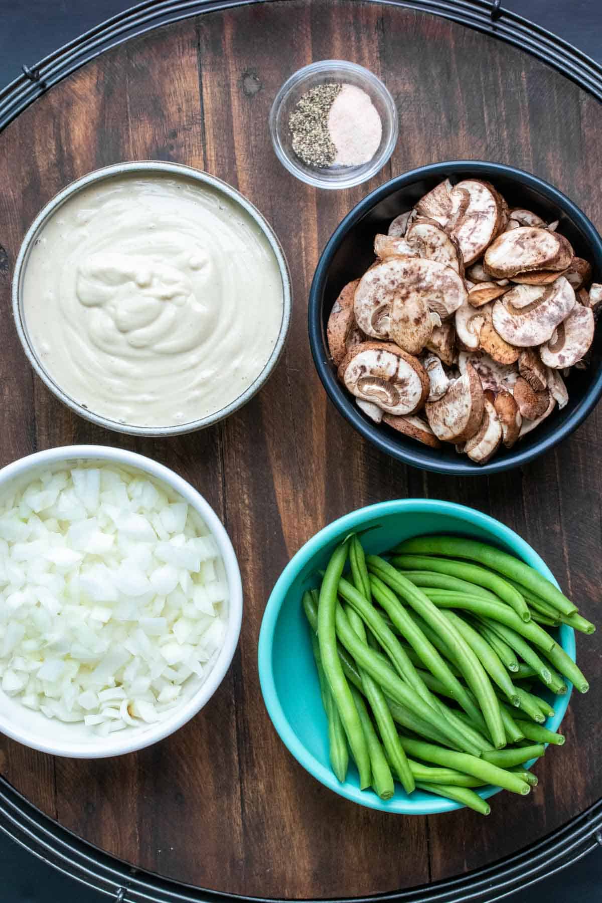 Bowls filled with ingredients for green bean casserole