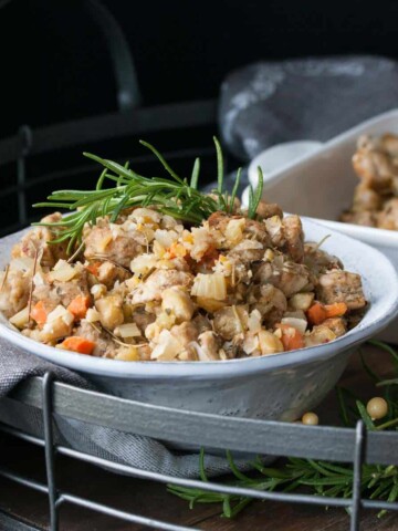 White bowl on a metal tray filled with bread stuffing