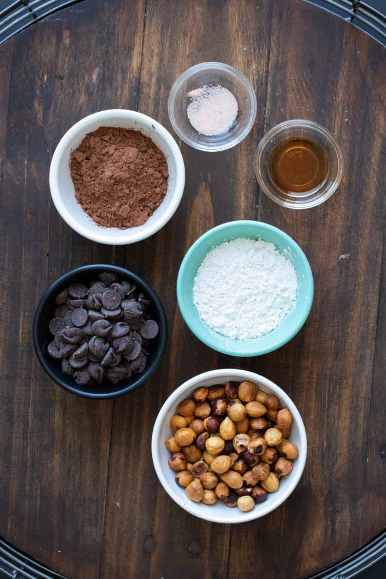 Ingredients to make homemade Nutella in different colored bowls